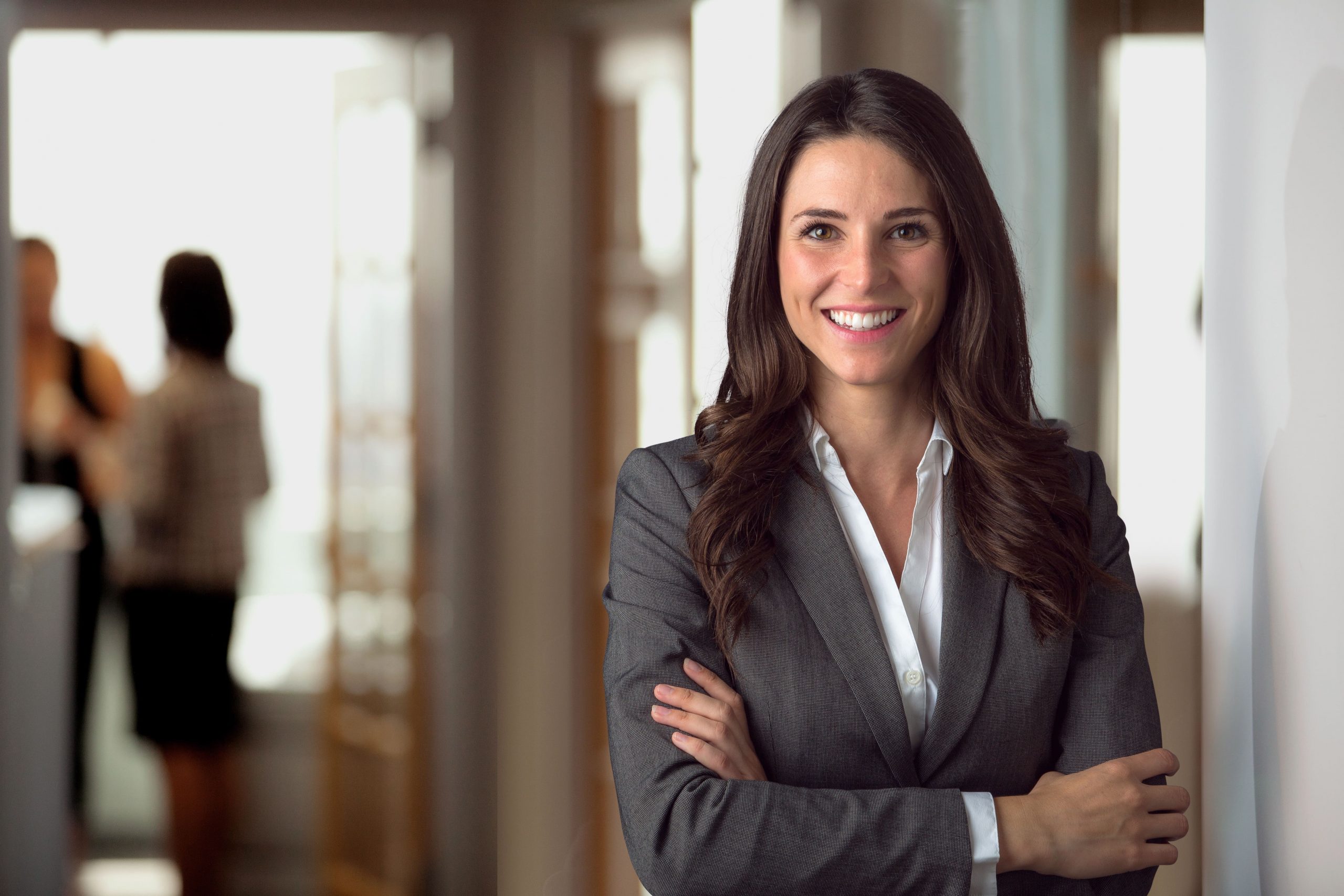 women in professional suit smiling at the camera