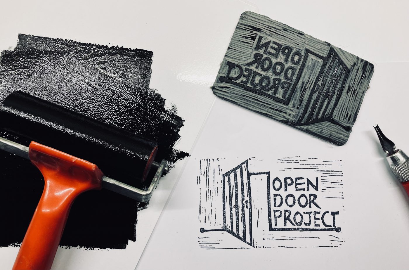 open door project logo with roller paint